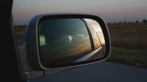 Sunset View In Right Side Mirror In Car Driving On The Road