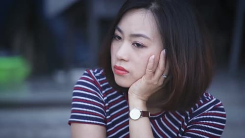 Pensive Woman Gazing Sideways in Daylight