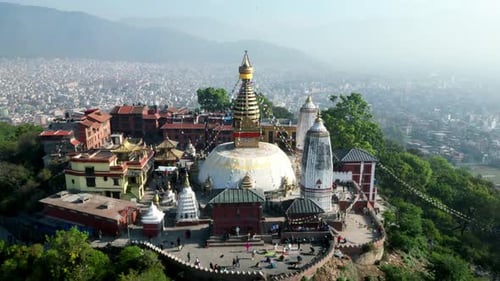Aerial landscape view of Swayambhunath temple, ancient buddhist stupa with hanging prayer flags, wit
