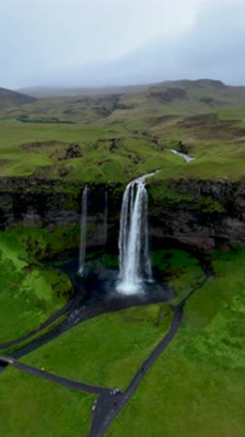 Aerial shot of Iceland Waterfall and Green Landscape