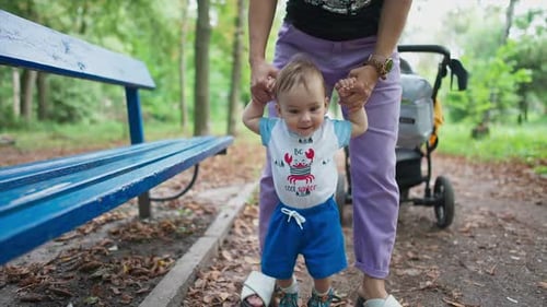 Baby's First Steps with Mother in Park