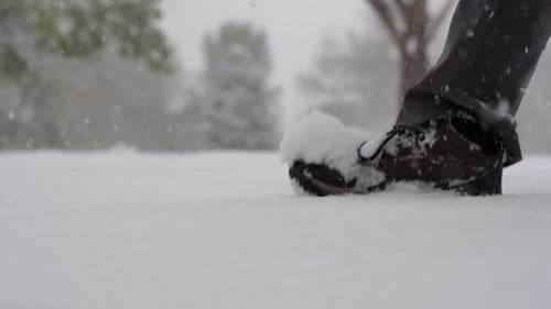 Slow motion footage of foot steps on snow