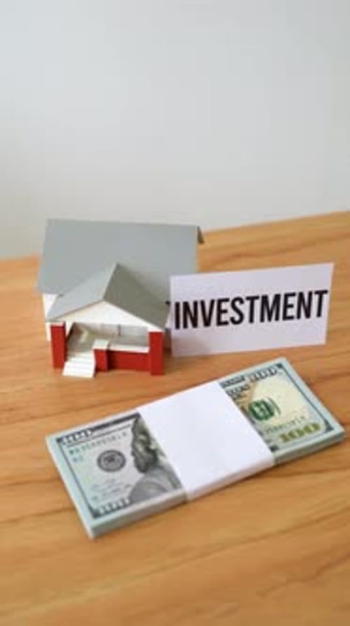 Concept of investing cash in houses and real estate. Secure investment. Vertical shot.