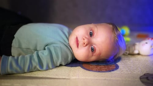 Adorable Baby Laying on a Mat Close Up