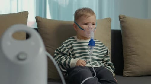 Boy Using Nebulizer Mask for Respiratory Treatment