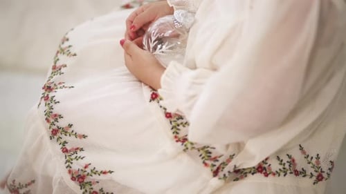 Child Holds Christmas Ornament Close Up