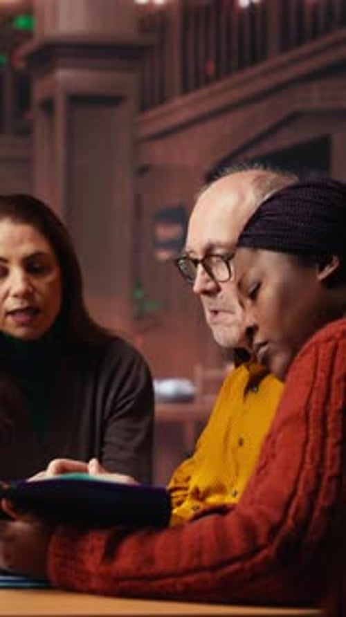 Vertical Video Mature Team of People Reviewing Materials and Class Work for University Degree