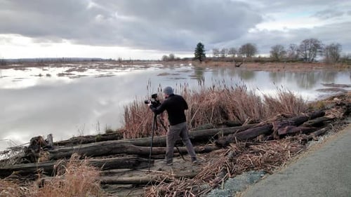 Photographer Taking Pictures of a Rural Lake