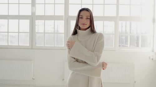 Woman Posing in Cream Sweater in Bright Room