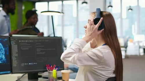 Focused Coder Working at Dual Monitor Computer