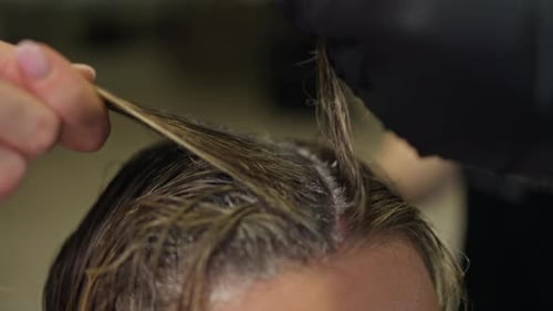 Woman gets her hair dyed in salon