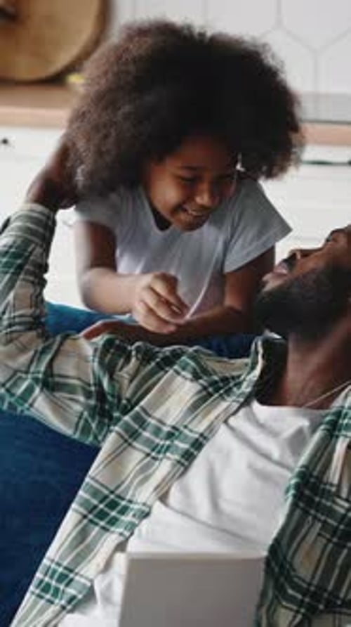 Loving Child Giving Father Homemade Card in Kitchen