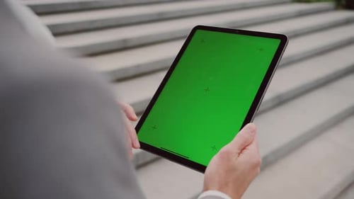 Close Up of Employee Using Tablet with Chroma Key Screen