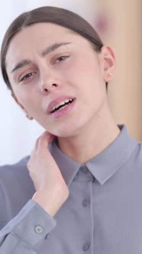 Young Woman Massaging Neck Due to Pain