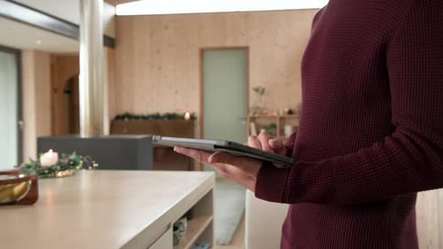Young Adult Using Tablet for Smart Home Control