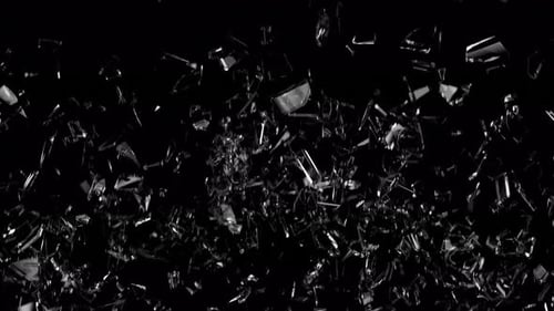 Glass breaking. Flying glass shards. Broken glass on a black background. Broken glass shard.