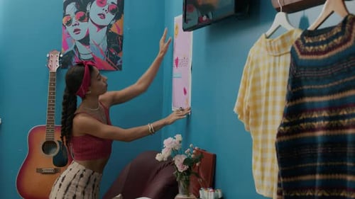 Woman Decorating Room with Art and Personal Touches