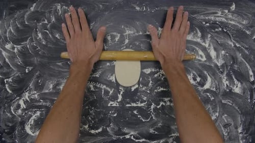 Hands Roll Dough Overhead for Baking Preparation
