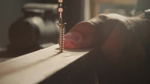 Close Up of Power Drill Screwing in Screw