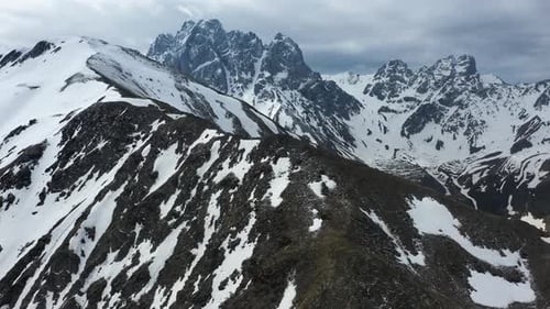 Cinematic epic drone shot of the snow covered Georgian Dolomites in the Caucasus mountains in Georgi