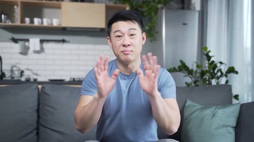 Man Gesturing and Speaking Positively Indoors