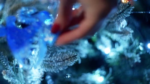 Decorating a Christmas Tree with a Dragon Ornament