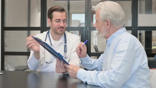 Doctor Explains Paperwork to Senior Patient in Office