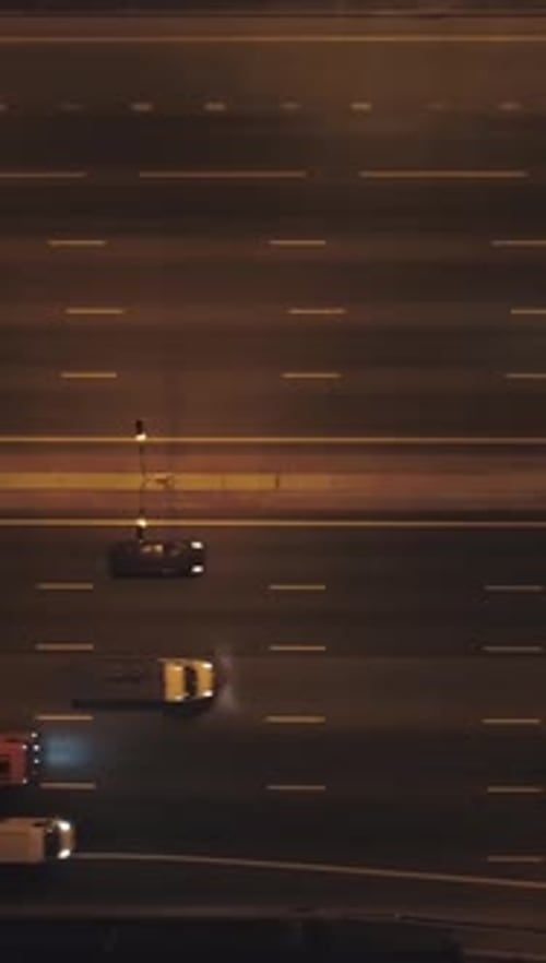 Cars on Illuminated Highway in City at Night Aerial Vertical TopDown View Vertical Video