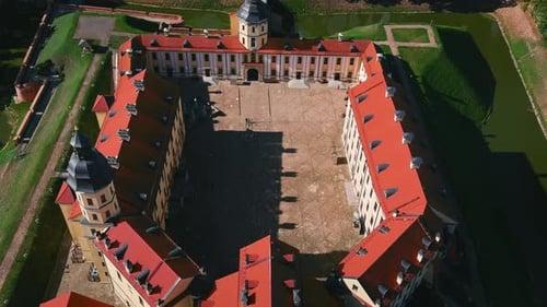 Aerial view on the Nesvizh castle and park in summer. Moving over medieval castle. Cinematic drone s
