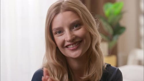 Smiling Woman Gesturing Indoors
