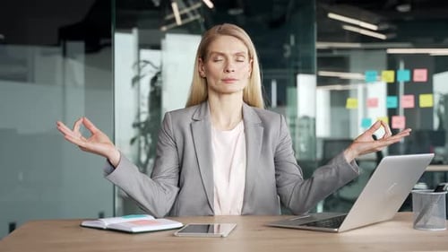Woman Meditating at Her Office Desk