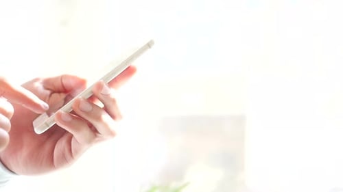 Side View of Hand Text Messaging on Phone