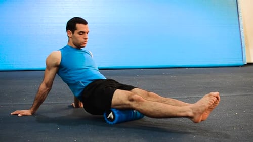 Man Using Foam Roller for Leg Muscle Recovery