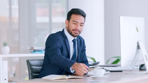 Young Adult Man Working at Desk in Office