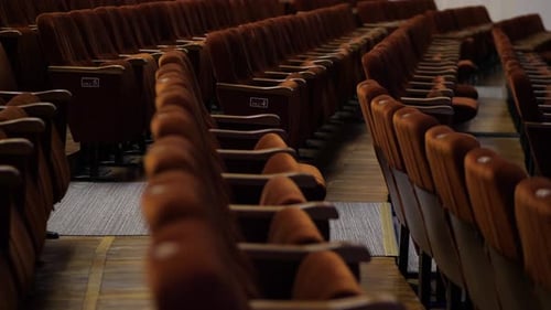 Rows of Empty Bright Spectator Seats in an Empty Hall Before the Show