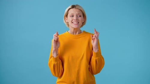 Woman Expressing Hope with Prayer and Crossed Fingers