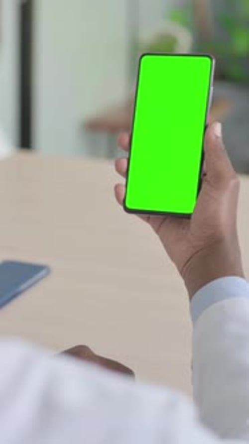 African Doctor Using Smartphone with Chroma Key, Vertical Video