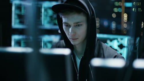 Young Adult Hacker Coding at Dark Computer Workplace