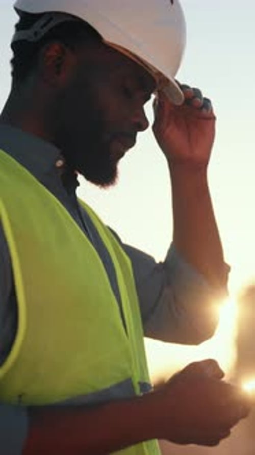 African American Builder Using Smartphone in Construction Site Vertical Portrait Outdoors Black Man