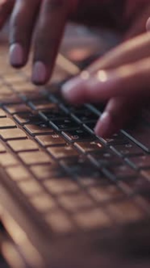 Hands Typing on Laptop Keyboard Close Up