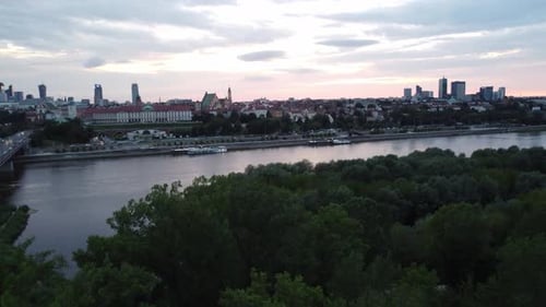 Cinematic drone footage of Warsaw skyline with vistula river and bridge filled with traffic with big