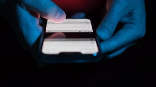 Close Up of Hands Using Cell Phone at Night