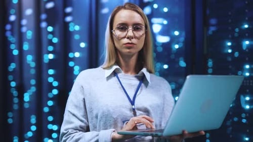 Woman Holding Laptop in Data Center