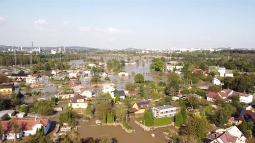 Widespread flooding in Ostrava, Czech Republic, with submerged houses and trees after a severe flood
