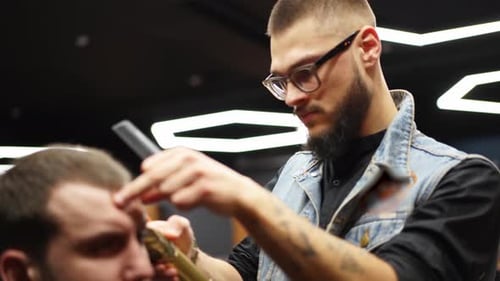 Bearded Barber Styles Hair in Modern Barbershop