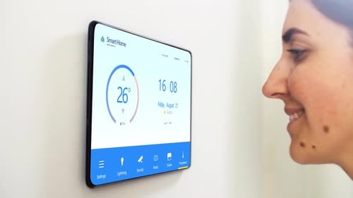 Woman Interacts with Smart Home Control Touchscreen Device