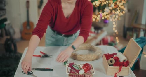 Woman Preparing Christmas Wreath Garland For Christmas Holidays