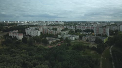City with high-rise buildings. Park area in the foreground. Blue sky with clouds. Aerial photography