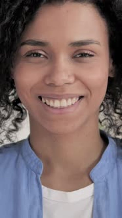Close Up of Smiling Young Woman in Blue Shirt
