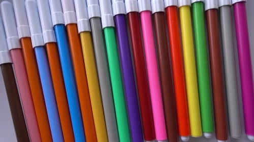 Colorful Markers Arranged Neatly on White Surface